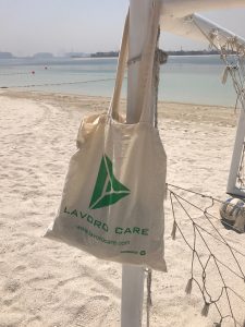 A lavorocare Jute Tote bag relaxing on the beach as part of our employee competition : We care about our clients : We care about our Staff : We care about our support workers.